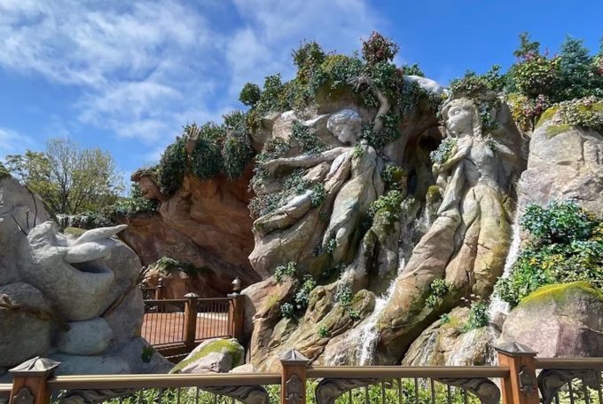 fantasy springs standby passes, rock formation with a waterfall and a fence