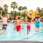 kids jumping into wdw all star and pop century pool