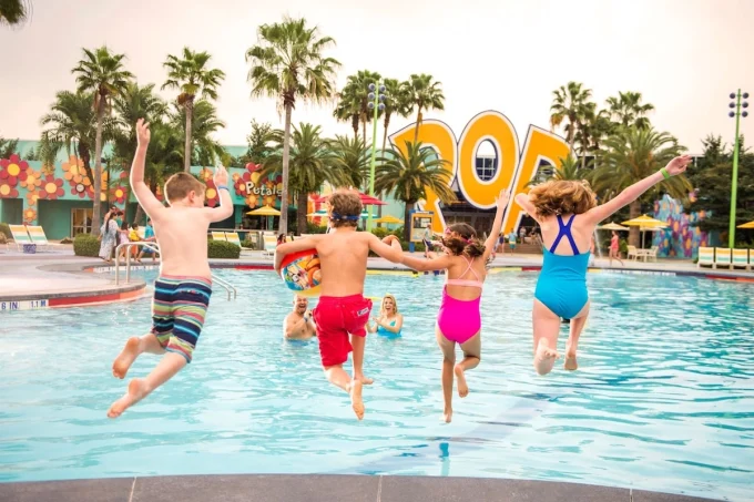 kids jumping into wdw all star and pop century pool